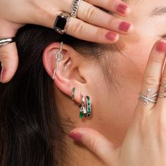 Delve into the green stone jewellery trend with these striking emerald green oval hoop earrings! Crafted from sterling silver with the option of 18ct gold plating, these elongated green chunky hoops are inlaid with 5 baguette-cut cubic zirconia stones that give your look an extra pop of bold green and stunning sparkle. They also feature a hinged clasp which allows for ease of taking this earring on and off.Your green light to effortless styling, these baguette earrings are the perfect accessory Tarnish Resistant Emerald Jewelry, Small Hoop Earrings For May Birthstone, May Birthstone Hoop Jewelry, Modern Green Cubic Zirconia Jewelry, Teardrop Hoop Earrings For May Birthstone, Trendy Green Huggie Jewelry, Green Sterling Silver Jewelry With Baguette Cut, Green Small Hoop Sterling Silver Jewelry, Green Emerald Hoop Earrings In Fine Jewelry Style