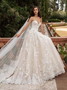 a woman in a wedding dress standing on a bridge