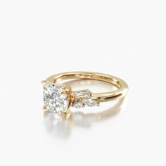 a yellow gold ring with two diamonds on it