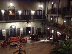 an indoor courtyard at night with tables and chairs