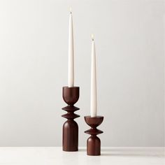 two candles sitting next to each other on a table