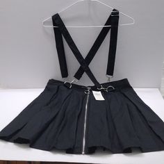 Pre-Owned / Hot Topic Black Pleated O-Ring Zipper Suspender Skirt Size Large. Spring Black Skirt With Side Zipper, Black Skirt With Zip Fly For Night Out, Black Skirt With Side Zipper For Spring, Black Mini Skirt With Zipper For Spring, Edgy Black Skirt With Zip Fly, Spring Black Skirt With Zip Fly, Black Spring Skirt With Side Zipper, Black Bottoms With Suspenders For Spring, Punk Style Black Mini Skirt With Zipper