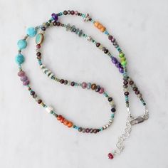 Riverstone Jewelry designer Jill Scholsohn creates vibrant jewelry using a mixture of amulets & talismans along with rare, exotic beads and mediums from sourced from several cultures spanning the globe. Turquoise, spiny oyster shell, 5mm ruby, sapphire, amethyst, apple coral, labradorite, crystal Sterling silver extender and lobster clasp 18-20" length All natural stones, slight variations in color will occur Handmade in CT Adjustable Multicolor Amulet Jewelry, Multicolor Handmade Artisan Turquoise Necklace, Handmade Multicolor Artisan Turquoise Necklace, Artisan Multicolor Handmade Turquoise Necklace, Spiritual Multi-stone Round Beads Gemstones, Spiritual Multi-stone Beaded Necklaces As Gifts, Bohemian Multicolor Gemstone Jewelry, Spiritual Multi-stone Beaded Necklace For Gift, Multicolor Handmade Amulet Jewelry