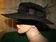 "Mr John black wool fedora style hat with 3 1/2\" wide banded brim, with flurry 5 to 6\" black feathered/ribbon bow band on one side. Possible 1950's era, with circumference of inside crown is 21\". Band is circled with wire band, so it can be shaped for your style. Hat is in very good condition. I believe the feathers are Ostrich. PRICE IS $99.00SALE FINAL/AS IS/NO RETURNS." Classic Black Boater Hat For Party, Black Formal Boater Hat With Flat Brim, Formal Black Boater Hat With Flat Brim, Black Wide Brim Felt Hat For Winter, Black Brimmed Costume Hat For Fall, Black Brimmed Fall Costume Hat, Brimmed Black Costume Hat For Fall, Black Brimmed Boater Hat For Formal Occasions, Black High Crown Fedora For Winter