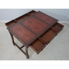 a wooden table with three drawers on each side and one drawer open in the middle