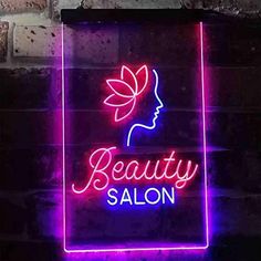 a neon sign that says beauty salon on it's side, in front of a brick wall