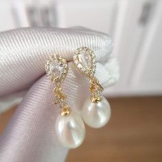 These stunning earrings feature lustrous oval pearls, accented with sparkling water drop-shaped zircons. The 18K gold plating adds a touch of modernity and makes them long-lasting, non-tarnishing for years! Pearl Type: Freshwater Pearls Pearl Quality: [Shape]: Oval [Size]: 8-9mm [Blemish]: None [Luster]: High Material: 18k Gold Plated Brass Note: Every pearl is unique. Items may vary from the pictures. Elegant Oval Pearl Earrings, Elegant Gold Plated Teardrop Earrings For Formal Occasions, Elegant Gold Pear-shaped Bridal Earrings, Oval Pearl Charm Earrings For Wedding, Elegant Gold Pear-shaped Pearl Earrings, Gold Oval Bridal Earrings, Elegant Oval Teardrop Earrings For Formal Occasions, Gold Plated Teardrop Pearl Earrings, Gold-plated Teardrop Pearl Earrings