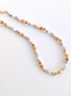 The perfect spring necklace 🌼 Choker style Gold-filled chain, clasp, & extender Intended for ages 2 years & up. Cute Beaded Necklaces With Tiny Beads For Summer, Trendy White Beads For Summer, Trendy White Summer Beads, Bohemian Jewelry With Letter Beads For Spring, Spring Gift Beaded Necklaces With Tiny Beads, Cute Flower Beaded Necklaces With Colorful Beads, Bohemian Beaded Bracelets For Everyday Spring Wear, Bohemian Beaded Bracelets For Spring, Trendy White Beads For Festival