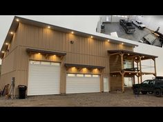 two garages with lights on each side and a truck parked in front