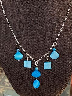 Turquoise colored shapes make up this cute necklace and dangle earring set.