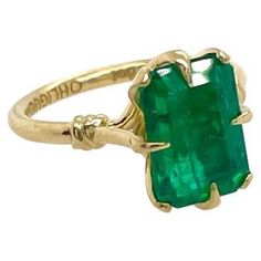 Glamorously bold and unabashedly seductive. This showstopper ring features a glorious claw set Emerald, embraced by small golden ropes and a one of a kind stone set within a petal basket. •Available in 18ct Yellow, White & Rose gold •Ethically sourced emerald cut Emerald Every OHLIGUER jewel is custom made to order and requires six to eight weeks production time. Please contact our customer service team after purchase to discuss your size and track the production of your piece. engagement or sol Antique Emerald Engagement Ring, Antique Cushion Cut Diamond, Antique Cushion Cut, Emerald Cut Engagement Ring, Antique Cushion, Contemporary Engagement Rings, Elongated Cushion, Emerald Cut Engagement, Cushion Cut Diamond