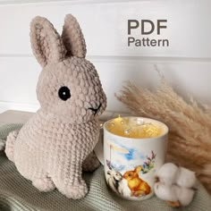 there is a stuffed rabbit next to a mug