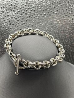 A classic design ladies Sterling Silver bracelet designed in round Cuban links.   Weight:  18.2 grams Length:  7" Our Price $189.00 Regularly Priced At $360.00 Please See Our Video Remember - If you're purchasing for yourself or a gift for a loved one, buy with confidence.  We Guarantee Everything We Sell!  SKU #B808 Cheap Nickel-free Sterling Silver Round Bracelet, Luxury Elegant Sterling Silver Bracelet With Clasp, Classic Jewelry Bracelet With Rolo Chain, Classic Bracelet Jewelry With Rolo Chain, Classic Rolo Chain Bracelets, Classic Sterling Silver Bracelet With Toggle Clasp, Sterling Silver Round Bracelet With Chain For Everyday, Formal Rolo Chain Bracelet Jewelry, Classic Silver Bracelet With Rolo Chain