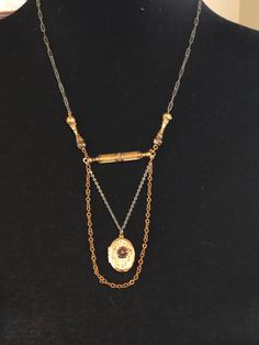 1910s locket with trapeze chain. This small gold colored locket has a rose center front. It opens to two spaces for photos. It has a mixed silver and gold tone chain. It measures25 in. in length. The locket is 7/8 in. long and 1/2 in. in width. Vintage Silver Delicate Chain Necklace, Vintage Silver Chain Necklace With Delicate Chain, Victorian Rose Gold Necklace With Vintage Charm, Victorian Rose Gold Medallion Necklace, Vintage Gold Multi-layer Chain Necklace, Antique Rose Gold Necklace With Vintage Charm, Heirloom Rose Gold Necklaces With Vintage Charm, Heirloom Rose Gold Necklace With Vintage Charm, Rose Gold Antique Necklace With Vintage Charm