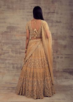 Minimalist Yet Elegant Gold Lehenga For Our Beautiful Ladies! All the women - whether they are from India or any other country have always embraced the unparalleled charm of Lehengas. Lehenga has become the preferable attire for a wedding or special occasion owing to the kind of comfort and elegance this attire provides. Keeping in mind your taste and class, Ruhani Collection have come up with this beautiful gold-coloured lehenga. Beautified with silver and gold embroidery, this lehenga is enoug Elegant Floor-length Sharara For Ceremony, Floor-length Choli With Sheer Dupatta For Wedding, Wedding Anarkali Set With Sheer Dupatta, Traditional Anarkali Wedding Dress For Ceremony, Floor-length Sharara With Cutdana For Wedding, Floor-length Cutdana Sharara For Wedding, Wedding Floor-length Sharara With Cutdana, Full Length Lehenga With Resham Embroidery For Reception, Gold Anarkali Wedding Dress With Traditional Drape