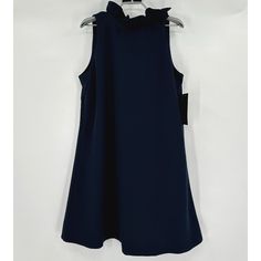 Tuckernuck Women's Blythe Dress Color: Navy Blue Size: Large Retail: $198 Condition: New With Tags Reinforced 2" Ruffle Stand Collar Sleeveless Bow Tie Back Swing Shape Soft Stretch Crepe Fabric Mini Length 97% Polyester, 3% Spandex Machine Wash Cold, Hang To Dry 19.5" Pit-To-Pit 37" Shoulder To Hem Blue A-line Sleeveless Dress With Ruffles, Blue Sleeveless A-line Dress With Ruffles, Navy Sleeveless Dress With Ruffles, Dressy Sleeveless Mini Dress With Ruffles, Navy Ruffled Dress For Party, Navy Party Dress With Ruffles, Ruffled Sleeveless Dress For Workwear, Chic Navy A-line Dress, Elegant Blue Ruffled Sleeveless Dress