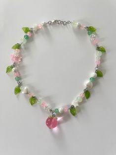 pink and green beaded necklace with pink peach charm. whimsical fairy like necklace with green leaf charms. silver metal Pink And Green Beaded Necklace, Pink And Green Necklace, Beaded Necklace Inspiration, Pink And Green Jewelry, Green Beads Necklace, Beading Necklace, Collar Rosa, Peach Necklace, Leaf Beads