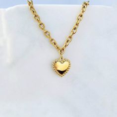 "The Oh My Heart Necklace is a gorgeous statement handmade piece made of 18k gold plated stainless steel, this unique necklace can be used as a statement piece for an effortless look or can be layered with other necklaces. ITEMS DETAILS: Water Resistant - Tarnish-free - Skin Friendly Material: 18k gold layer over stainless steel Length 18¨ + 2\" extender chain Adjustable Jewelry Care We at Alma Libre Jewelry understand that every person is different and we each have unique skin-oils that may rea Gold Plated Necklaces With Heart Beads, Gold Plated Necklace With Heart Beads, Gold Heart Beads Necklace For Gift, Gold Necklaces With Heart Beads For Gift, Handmade Gold Charm Necklaces For Valentine's Day, Handmade Gold Charm Necklace For Valentine's Day, Gold Stainless Steel Necklace With Heart Charm, Valentine's Day Gold Plated Heart Necklace With Chain, Valentine's Day Gold Plated Charm Necklace