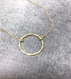 Gold Circle NecklaceThis dainty gold open circle necklace features a beautifully hammered circle delicately suspended from a strong, but dainty gold filled chain. The perfect minimalist necklace!  Available in sterling silver or gold.-26mm gold filled hammered circle.-Dainty gold filled cable chain.- I do offer a gift wrapping option for gift giving purposes.GOLD-FILLED JEWELRY:- 14kt Gold filled offers an economical alternative to solid gold.- 14kt Gold filled jewelry is made by bonding a solid Gold Open Circle Jewelry With Delicate Chain, Gold Jewelry With Delicate Chain And Open Circle, Dainty Jewelry With Delicate Open Circle Chain, Gold Jewelry With Delicate Open Circle Chain, Gold Jewelry With Delicate Chain In Open Circle, Dainty Open Circle Jewelry With Delicate Chain, Dainty Hammered Circle Jewelry, Gold Minimalist Open Circle Charm Necklace, Minimalist Gold Open Circle Charm Necklace