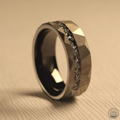 a wedding band that is made out of wood and has an intricate design on it