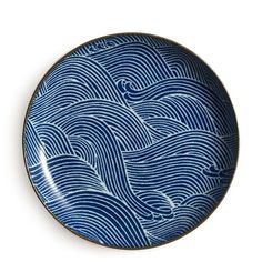 a blue and white plate with waves on it