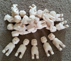 a group of small wooden figures sitting on top of a carpet