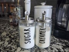 two salt and pepper shakers sitting on top of a counter