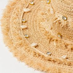 Embrace the sun while keeping cool and stylish with our Chic Raffia Sun Hat. Handcrafted from high-quality raffia, this hat is a must-have accessory for any beach goer or outdoor enthusiast looking to combine fashion with functionality. The elegant shell decoration adds a touch of seaside charm, making it a standout addition to your summer wardrobe. Key Features Sun Protection: Enjoy your day in the sun without the worry, as our hat offers excellent protection against harmful UV rays. Material: Toquilla Straw Hat For Beach Season Festivals, Bohemian Straw Sun Hat For Vacation, Beach Festival Toquilla Straw Sun Hat, Toquilla Straw Sun Hat For Beach Season Festivals, Beachy Toquilla Straw Hat For Festival, Natural Straw Hat For Beach Festival, Sun Straw Hat For Beach Season Vacation, Sun Straw Hat For Beach Vacation, Beachy Straw Sun Hat For Festivals