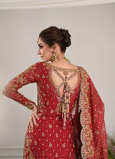 Pakistani Bridal Outfit in Kameez and Lehenga Style is an epitome of tradition and royalty. Hand-crafted details of dabka, zari, sequins, dabka, and naqshi make this beautiful Lehenga Dress an epitome of beauty and your foremost priority to have a head-turning magical look on the big day. Lehenga Kameez: The stunning kameez in an alluring red color is beautifully embellished with the intricate zardosi and fine details of embroidery, threads, motifs, dabka, naqshim, gold silver zari, and sequins. Premium quality cotton net fabric and perfect stitching make this Pakistani Bridal Dress a perfect choice to have a gorgeous wedding look. Bridal Lehenga: The embellished kameez is paired with Bridal Lehenga, creating a lavish Pakistani Bridal Outfit. The Farshi Lehenga has an alluring purple shade Designer Dabka Choli For Navratri, Navratri Designer Choli With Dabka Embroidery, Navratri Designer Dabka Choli, Anarkali Choli With Dabka Detail In Chinon, Traditional Sharara With Dabka For Designer Wear, Anarkali Kundan Gown For Traditional Ceremonies, Anarkali Choli With Dabka On Chinon, Traditional Gown With Dabka Work For Designer Wear, Bollywood Style Festive Lehenga With Dabka Detailing