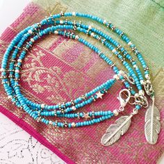 This turquoise beach anklet features a handmade silver feather charm and is intricately beaded with Indian style silver and turquoise glass seed beads. With dual strands and a little silver star added for good measure, this ankle bracelet has an adjustable chain allowing you to personalise the length to fit you perfectly. The strands can sit separately around your ankle or you can twist them together before you do up the clasp for a different look. Threaded onto tigers tail jewellery wire and held together with a slightly larger lobster clasp for ease of use, this turquoise beauty is wonderfully light to wear. Beautiful for a boho bride, day at the beach, casual or evening wear - this is an original myVardoJewellery design.  Your anklet will arrive in our signature beautiful and eco-friend Bohemian Silver Beads Anklets For Beach, Bohemian Silver Beaded Anklets For Beach, Blue Beaded Bracelets With Silver Beads For Festivals, Turquoise Anklets With Tiny Beads For Festival, Turquoise Beaded Anklets For Festival, Turquoise Round Beads Anklet For Festivals, Turquoise Round Beads Anklets For Festival, Turquoise Anklets With Round Beads For Festivals, Turquoise Beaded Festival Anklets