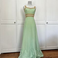 Vintage handmade mint green tank dress from the 1960s. Features a fitted bodice and pastel rainbow trim on the waist and sleeves. Every detail feels tailored and feminine. Skirt is full maxi length with a bottom tier. Best fit for modern size 00/0 or xxs. Fabric has no stretch so be sure to check measurements. No flaws to note - excellent condition! Bust: 30" Waist: 24" Skirt Length: 44.5" Fitted Green Maxi Dress With Empire Waist, Feminine Skirt, Chattanooga Tn, Green Tank, Pastel Rainbow, Fitted Bodice, Dress Clothes For Women, Tank Dress, Skirt Length