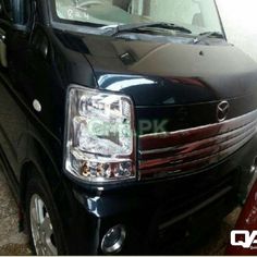 the front end of a black van parked in a garage