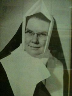 an old black and white photo of a nun