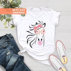 "Floral Horse Shirt, Horse Lover Tee, Flower T-Shirt, Gift For Her, Women Country Tee, Animal Lover Present, Equestrian Shirt, Horse Girl Tee BLACK TEXT is used by for Yellow, Heather Peach, White, Light Gray Heather Shirts. WHITE TEXT is used by Other Colored Shirts. Hi! Welcome. It's great to see you here! ☺️  Our shirts are clean, high quality and soft. It is prepared quickly by our boutique.  Ironing and shipped.  Enjoy your shopping!  It is a pleasure for us to help you with your questions Equestrian Shirt, Country Tees, Pink Shirts, Farmer Shirt, Horse Shirt, Horse T Shirts, Country Shirts, Gifts For Horse Lovers, Girls Tees