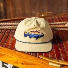 -Embroidered Fish design -Lightweight Nylon Fabric -6 Panel Unstructured Cap -Multi-colored Rope -Flat Brim Visor -Mid Height Crown -Plastic snapback closure Free Shipping on all Hats 5panel Cap, Minimalist Wardrobe Men, Rope Hats, Caps Ideas, Fish Hat, Wardrobe Men, Embroidered Fish, Fishing Hats, Colored Rope