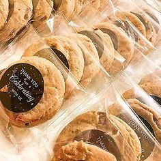 some cookies are in plastic containers on a table with labels that say, thank you for being served