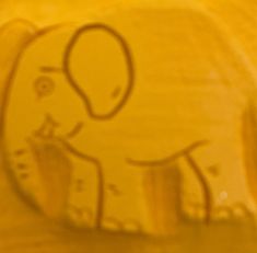 an elephant drawn on the side of a yellow wall