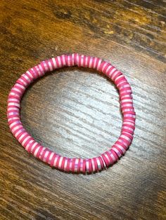 Beautiful pink and purple clay bead bracelet. Pink Hand-strung Bangle Stretch Bracelet, Pink Heishi Beads Bracelet With Colorful Beads, Pink Heishi Beads Bracelets With Colorful Beads, Handmade Pink Heishi Beads Stretch Bracelet, Pink Heishi Beads Bracelets As Gift, Pink Beaded Letter Bracelets Bangle, Pink Beaded Bangle Bracelet With Letter Beads, Pink Beaded Bangle Bracelets With Letter Beads, Pink Hand-strung Stretch Bracelet For Beach