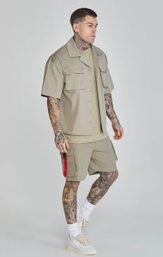 Khaki Flight Utility Shirt Branded tape logo Relaxed fit Custom buttons Utility chest pocket with buckle closure Machine Wash 100% Polyester Outfit Essentials, Utility Shirt, Dress Joggers, Custom Buttons, Mens Khakis, Clothing Essentials, Jogger Jeans, Trouser Jeans, Dresses With Leggings