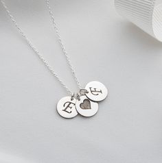 Personalized Initial Discs Necklace | Multi Disc Necklace | Engraved Initial Letter Necklace | Personalized Gift Elevate your style with our exquisite Silver Coin Pendant Jewelry, a perfect blend of elegance and personalization. This beautiful Multi Disc Necklace features meticulously crafted silver coin pendants, each engraved with an initial of your choice, making it a truly unique and meaningful accessory. Product Features: Premium Quality: Made from high-quality sterling silver, ensuring dur Silver Medallion Necklace For Anniversary Gift, Engraved Stainless Steel Jewelry With Initial Pendant, Engraved Stainless Steel Heart Pendant Jewelry, Valentine's Day Engraved Medallion Jewelry, Initial Pendant Locket Necklace With Charms As Gift, Stamped Sterling Silver Heart Pendant Necklace, Personalized Engraved Silver Jewelry, Engraved Round Pendant Name Necklace For Valentine's Day, Elegant Silver Hand Stamped Charm Necklaces