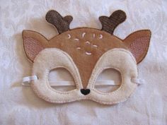 a close up of a deer mask on a white sheet with a lace border around it