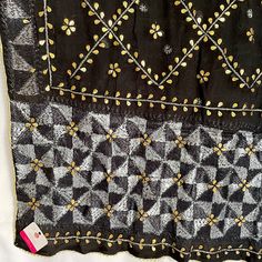 This traditional black silk phulkari gotta patti work dupatta is meticulously crafted with luxurious pure Chinon silk, featuring all over Gotta Patti hand embroidery and boasts a striking metallic gold trim along the border. This classic piece is perfect for celebrations such as weddings, sangeet, jaago, and chunni ceremonies. Effortlessly pair this dupatta with any color for an elegant contrast and make it an admirable present for birthdays or anniversaries. Material: Pure silk chinonWork: Silk Black Kurta With Cutdana Traditional Drape, Black Embroidered Fabric For Designer Wear During Eid, Elegant Black Salwar Kameez With Cutdana, Black Silk Embroidered Fabric For Wedding, Black Traditional Wear With Resham Embroidery In Chinon, Unstitched Black Traditional Wear With Chikankari Embroidery, Black Raw Silk Saree With Cutdana, Black Embroidered Dola Silk Saree, Elegant Black Chikankari Embroidered Fabric