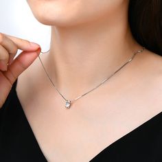 This stunning jewelry necklace for women features a brilliant moissanite diamond pendant that dazzles with every movement. Perfect as a statement piece or for everyday elegance, our moissanite necklace offers a touch of luxury. Discover the beauty of moissanite necklaces designed to captivate and inspire. ✧ Carat Weight: 1Ct ✧ Stone Dimension: 6.5mm ✧ Necklace Length: 18" ✧ Stone Shape: Round ✧ Enhancement: Lab Created ✧ Stone Color: Diamond White ✧ Stone Clarity: VVS1 ✧ Stone Grade: E ✧ Stone C Silver Moissanite Minimalist Necklace, Minimalist Silver Moissanite Necklace, Minimalist Silver Moissanite Solitaire Necklace, Lab Grown Diamond Necklace With Single Diamond, Diamond White Moissanite Pendant Necklace, Silver Minimalist Moissanite Diamond Necklace, Minimalist Silver Moissanite Diamond Necklace, Moissanite Solitaire Necklace With Round Pendant, Clavicle Chain Necklace With Moissanite