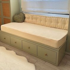 a day bed with drawers underneath it in a bedroom