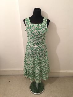 Pretty summer dress in a lightweight green and weight cotton Square neckline, fitted bodice with a zip to side of bodice Large frill hem Calf length/ maxi dress  Most likely handmade  Best fit size UK 10 or 10-12 or size medium  Bust 33 inches/ 84cm Hips free Length (top of back to hem)  105cm Green Fitted Sleeveless Midi Dress, Green Sleeveless Midi Dress With Fitted Bodice, Green A-line Cotton Midi Dress, Green Dresses With Floral Print And Fitted Bodice, Green Floral Print Dresses With Fitted Bodice, Green Floral Print Dress With Fitted Bodice, Fitted Green Sundress With Square Neck, Green Ruffled Sundress For Garden Party, Fitted Green Floral Maxi Dress