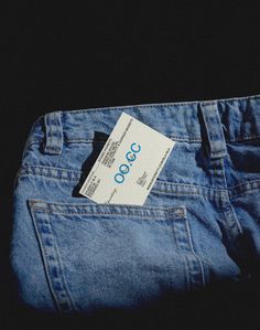 the back pocket of a pair of blue jeans with a white label that says occc