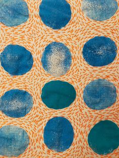 an orange and blue piece of art with circles on it's surface that looks like fabric