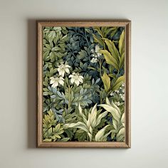 a painting hanging on the wall with green leaves and flowers