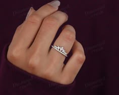 a woman's hand with a diamond ring on it