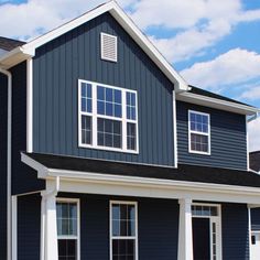 a blue house with white trim and windows